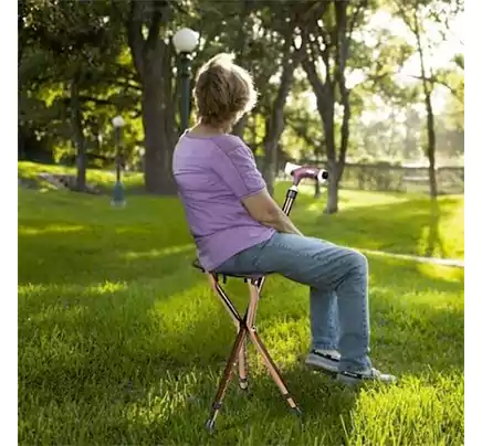 A woman sitting on a seat cane