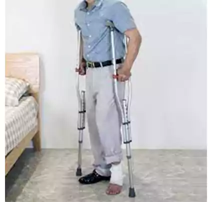 An injured person using underarm crutches