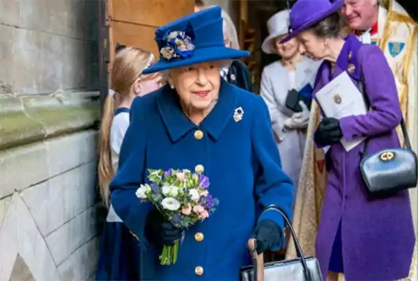 Queen Elizabeth walking with a ca